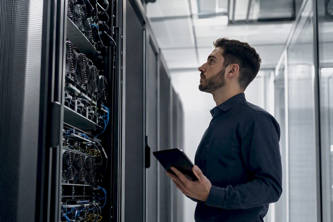 Technician monitoring server logs in data center